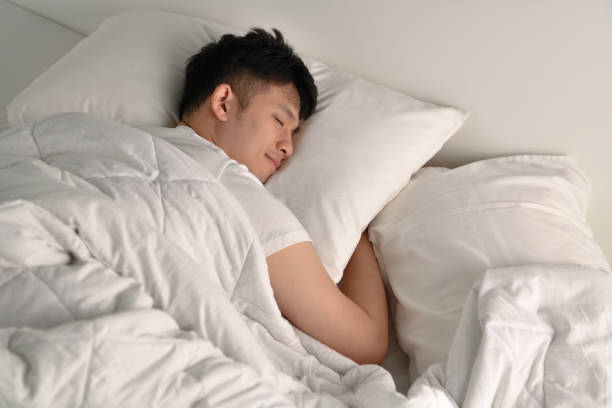 istock Handsome Young Asian man sleeping in bed 1333855870