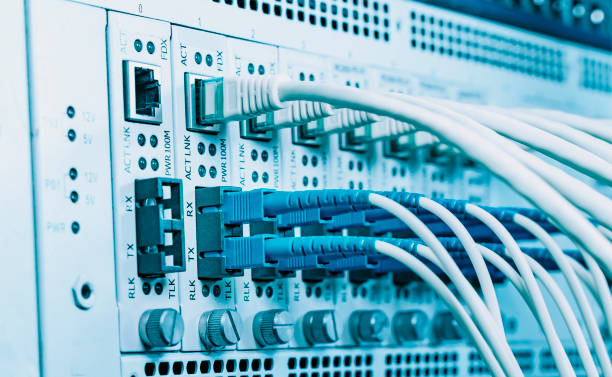 istock Fiber Optical cables connected to an optic ports and Network cables connected to ethernet ports 1333855904