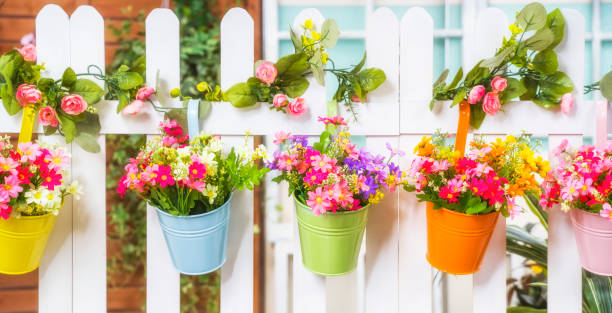 istock Hanging Flower Pots with fence 1333856015