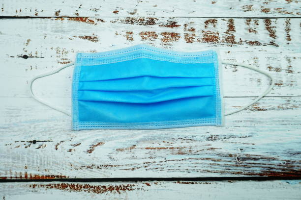 istock Medical Mask on wooden background 1333856111