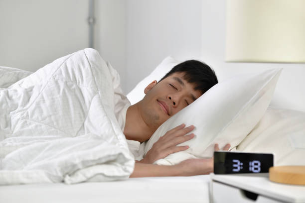 istock Handsome Young Asian man sleeping in bed 1333856657