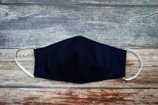 istock Reusable Fabric Face Mask on wooden background 1333856662