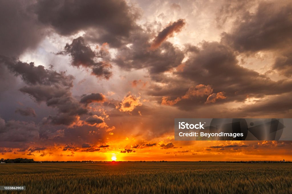 Fly-Away Sunset: disintegrating storm clouds dispersing at sunset Fly-Away Sunset as a severe storm disintegrates in the cooling evening with .... clouds dispersing and moving in different directions across the sky Sunset Stock Photo