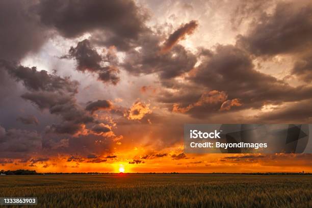 Flyaway Sunset Disintegrating Storm Clouds Dispersing At Sunset Stock Photo - Download Image Now