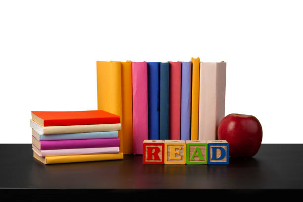 istock Stack of books and apple on tabletop against white background 1333869150
