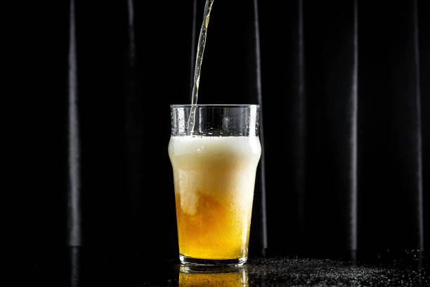 istock Beer. pouring beer into glass, with thick foam 1333872477