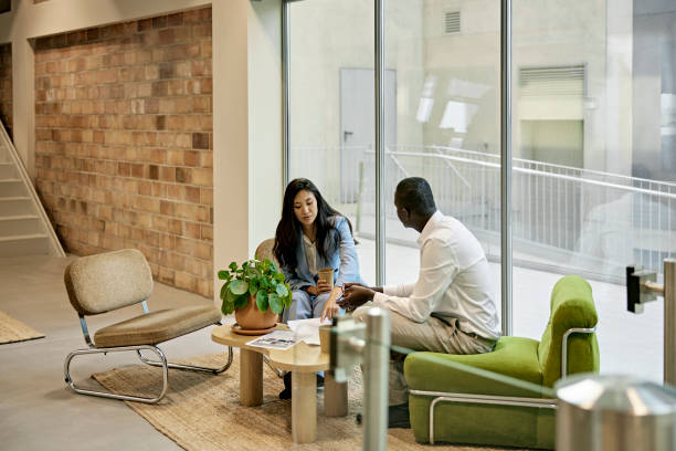 istock Black Businessman Examining Floor Plan with Korean Real Estate Agent 1333877310