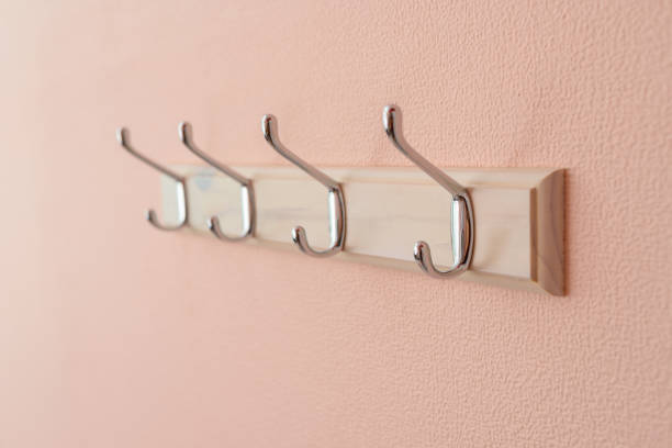 Clothes wooden hangers on pink wall
