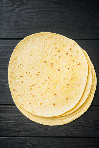 istock Corn Tortilla, on black wooden table background, top view flat lay  with copy space for text 1333880214