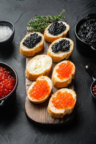 istock Canapes with black sturgeon and salmon fish caviar, on black background 1333880255