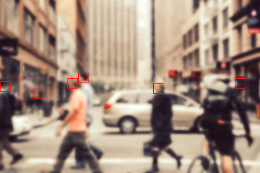 Face recognition signs and tags on people faces. Privacy and personal data protection. Blurred picture with drawn symbols.