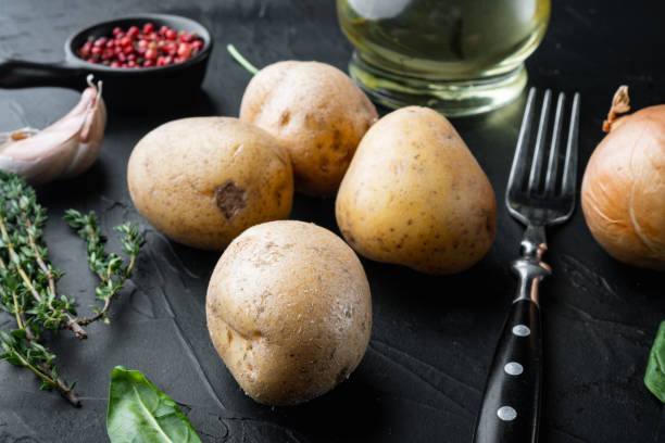 istock Fresh Pile of potatoes, on black background 1333881811