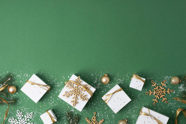 istock Christmas decorations with packaging gifts and Christmas tree on green background. Flat lay, copy space 1333886240