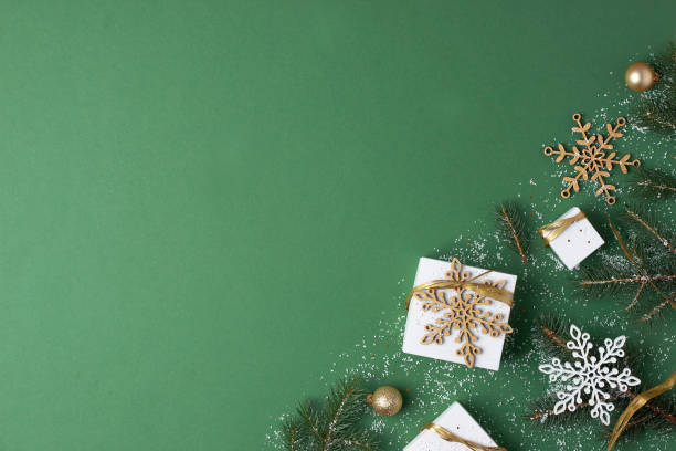 istock Christmas decorations with packaging gifts and Christmas tree on green background. Flat lay, copy space 1333886241
