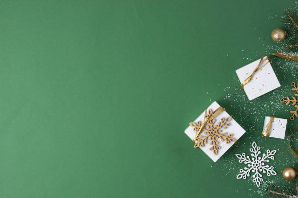 istock Christmas decorations with packaging gifts on green background. Flat lay, copy space 1333886248