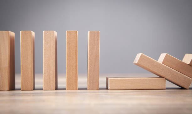 istock Falling wooden domino. Business. Crisis. Risk 1333886294