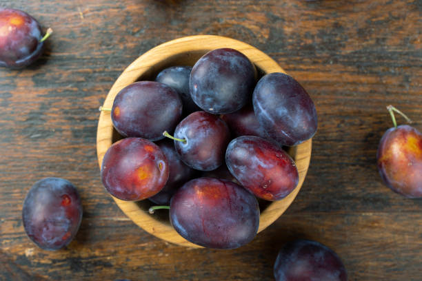 istock Fresh plums in a wooden bowl. Harvesting. 1333886445