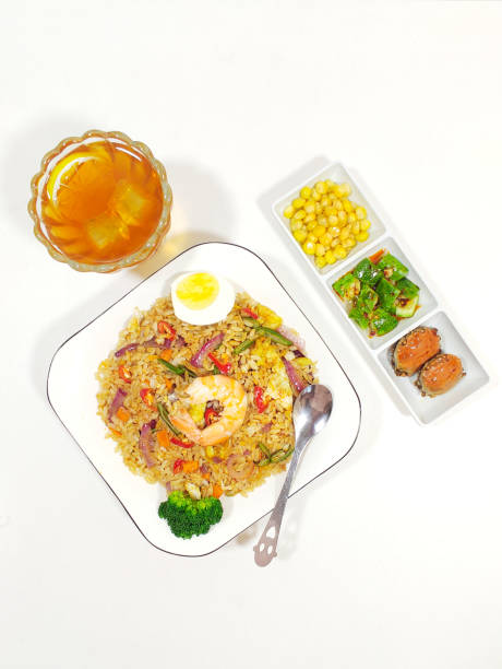 Healthy Asian cuisine, fried rice with egg, shrimp and broccoli. Corn, cucumber dip, crab, iced lemonade, top view Healthy Asian cuisine, fried rice with egg, shrimp and broccoli. Corn, cucumber dip, crab, iced lemonade, top view food state preparation shrimp prepared shrimp stock pictures, royalty-free photos & images