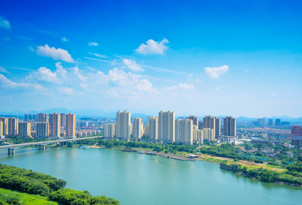 istock Under the blue sky, a river flows through the city with tall buildings. 1333887129