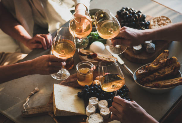istock People holding glasses with orange or rose wine over snacks 1333887509
