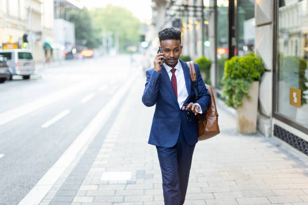 istock Businessman  rushing to the office, using phone 1333887600