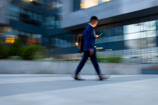 istock Businessman  rushing to the office, using phone 1333887654
