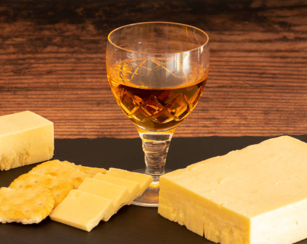 Christel Glass of Sherry Crackers and Cheese Block of cheese with crackers sliced apple and a glass of sherry on the side. sherry stock pictures, royalty-free photos & images