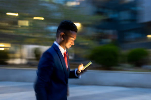 istock Businessman  rushing to the office, using phone 1333887677