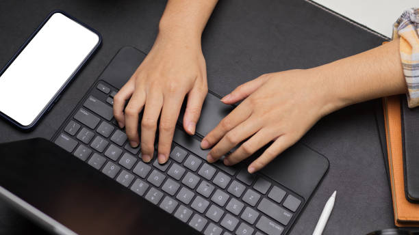 istock Female blogger using portable tablet, closeup hands typing on tablet keyboard 1333891758