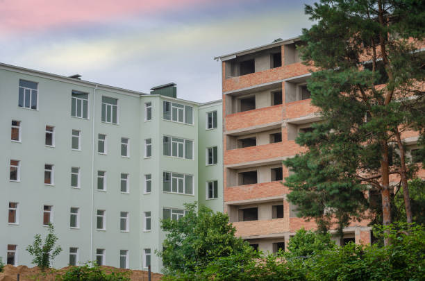 istock Two buildings on the construction site. A green structure and an 1333893395