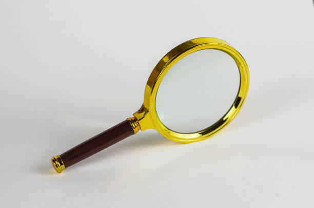istock A magnifying glass in a gilded frame with a brown handle on a wh 1333893396