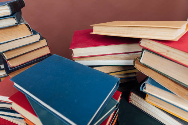 istock Stacks of books for teaching knowledge university library brown background 1333894395