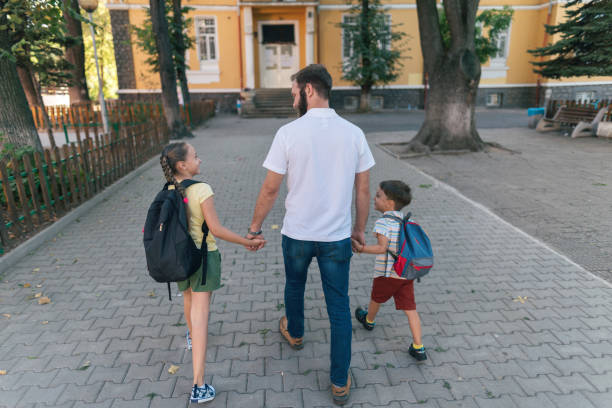 istock Father taking the kids to school 1333895419