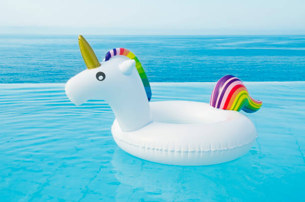 istock Funny inflatable unicorn ring floating in pool on sunny day 1333896362