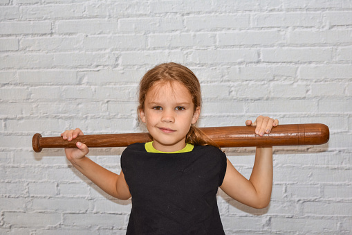 a child a girl with a baseball bat plays a bully