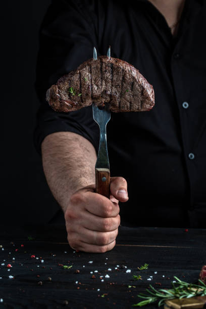 istock Chef hands cooking meat steak. Juicy Beef rump steak from marble beef medium rare 1333900627