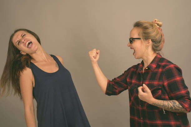 istock Young Woman Smiling While Standing Against Wall 1333905555