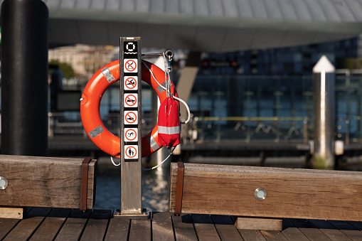 Life buoy and sign on a pier.