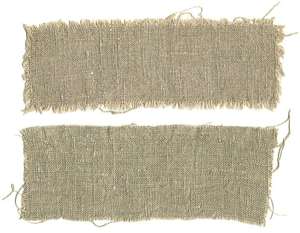 Two patches torn from a burlap sack Two pieces sackcloth isolated on a white background torn fabric stock pictures, royalty-free photos & images