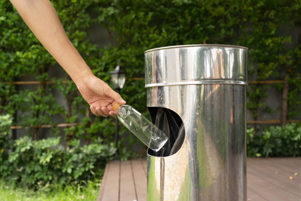 istock Hand throwing empty plastic water bottle in stainless steel bin. Rubbish, trash, waste or garbage. Outdoor. Environment. Recycle. 1333907581