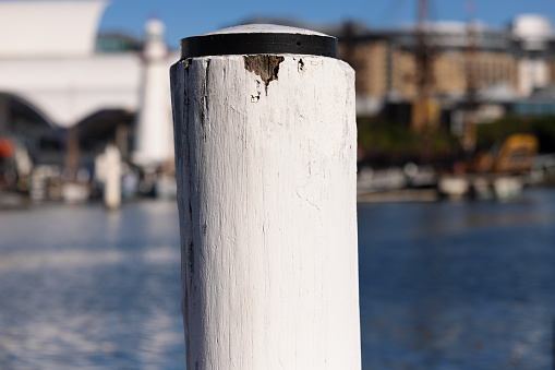 White post on a wharf showing signs of wear.