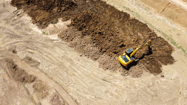 istock Backhoe or Excavator scraping a layer of soil 1333910904