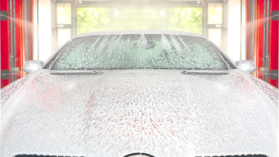 Foam on the hood of the car in the car wash