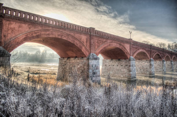 istock Long brick bridge over Venta river in winter day, Kuldiga, Latvia 1333912436