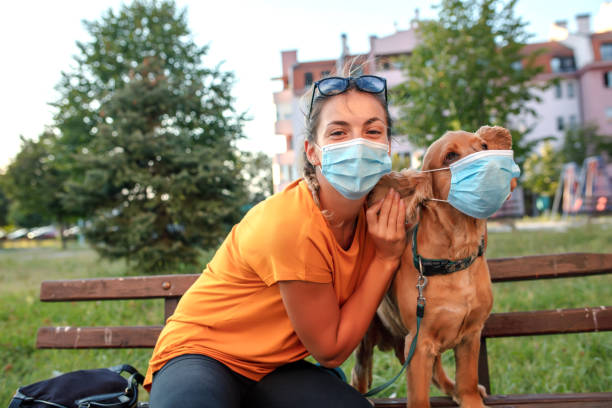 istock Woman and her dog with protective face mask 1333912846
