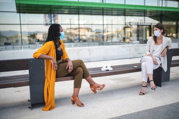 istock Businesswomen talking outdoors with social distancing 1333913452