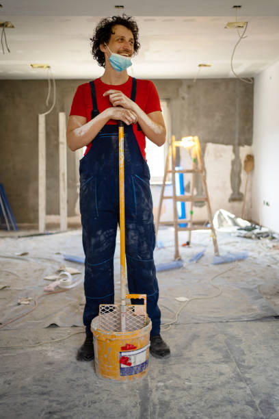 istock A smiling young worker with a mask works hard 1333913711