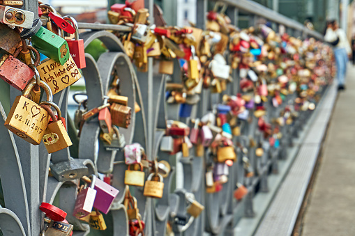 Close-up on love locks attached to a bridge in Paris France on the river Seine