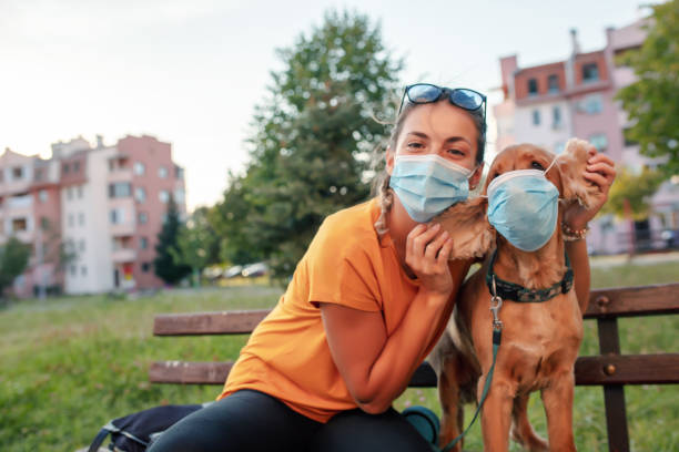 istock Woman and her dog with protective face mask 1333913926