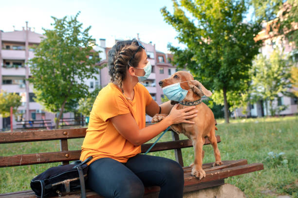 istock Woman and her dog with protective face mask 1333913936